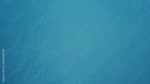 Flying over calm, deep blue color of sea water , background