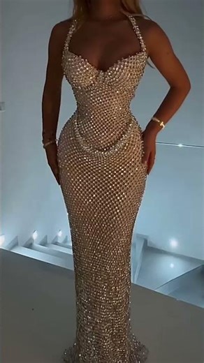To order this champagne dress DM This luminous champagne gown features a sculpted corset bodice