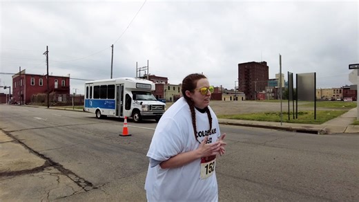Meredith Smith runs half marathon wearing 55 shirts
