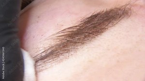 Permanent makeup. Permanent tattooing of eyebrows. Cosmetologist applying permanent make up on eyebrows- eyebrow tattoo.