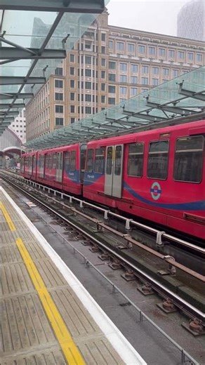 DLR Bombardier B90 on the DLR approaching and departing West India Quay for Stratford