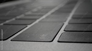 Human finger pressing on the enter return shift delete tab key on laptop keyboard