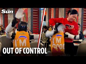 Out of control robot smashes up restaurant as waitress desperately attempts to drag it away
