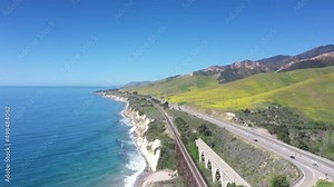 Famous US Highway Route 101 along the cliffs and beach with a stunning ocean view - aerial