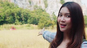 Asian lady with backpack recording video live streaming on phone upload in social media at lake.