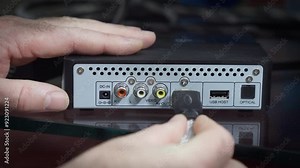 Connecting HDMI cable to set-top box.