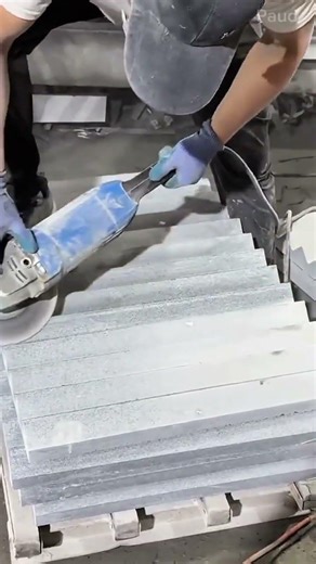 Cutting and smoothing several pieces of gray stone using a power grinder for precise construction