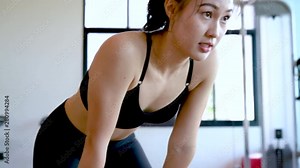 Woman fitness focused in the gym workout exercise building muscle and fit body people healthy lifestyle concept slow motion 4k resolution.