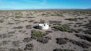 One of the detectors of the Pierre Auger observatory is seen close up with the Andes in the distance. The solar panel and antenna are clearly visible. In Malargue (Argentina)
