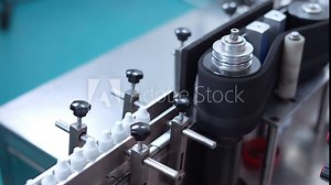 eye drop manufacturing. Ophthalmic drops solution, eye ear drop making process in factory. eye drop medicine in plastic bottles on conveyor belt. production of medical drops in a pharmaceutical line