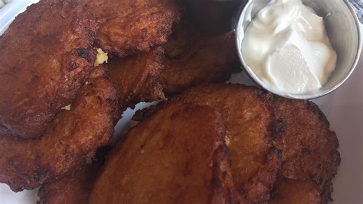 Holiday foods eaten by different cultures around Christmas, including gumbo, satay, latkes