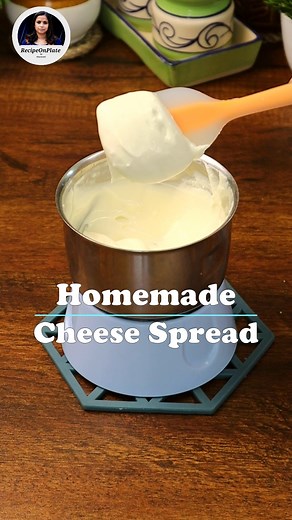 Homemade Cheese Spread Recipe Ingredients for 60g of cheese spread: For making the cheese: - 500ml full-fat milk - Juice of ½ a medium-sized lemon For the cheese spread: - Chhena (prepared cheese) - Pinch of salt - 3-4 tbsp fresh cream Instructions: 1. Begin by making the chhena. In a saucepan, pour 500ml of full-fat milk and bring it to a boil. Once it reaches boiling point, turn off the heat and add the fresh lemon juice. Stir for about a minute until the milk curdles and separates into cheese
