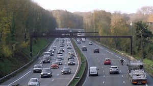 clip-1109189797-aerial-view-cars-driving-on-road-surrounded