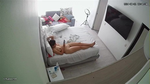 A Naked Brunette With Large Breasts Is Relaxing In Bed After A Shower