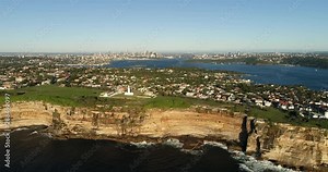 Surface of rolling waves hitting and undermining sandstone cliffs of Sydney eastern suburbs around south head under Macquarie lighthouse.