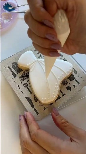 Decorating wedding dress cookies with royal icing