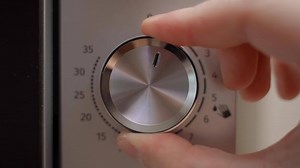 Selecting the cooking time in the microwave, close-up