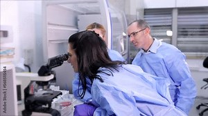 Three lab workers are doing research work at the laboratory