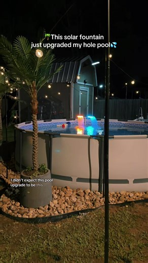 Such an easy pool upgrade. These solar pool fountains have adjustable spray, 10 different light colors, and they automatically turn on at dusk. Perfect for inground or above-ground pools. Makes the pool look so nice at night 💦 #poolupgrade #poolfountain #pooltok #backyardupgrade #poollife