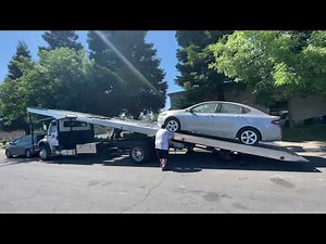 4 car rollback tow truck. Loading a non running car.