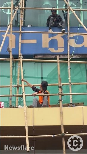 Builders make scaffolding from bamboo