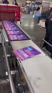 Book packaging. Automatic high speed shrink wrapping machine.