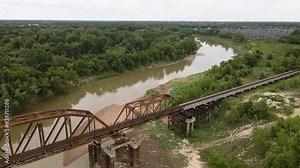 Muddy Brazos River With Old Railroad Bridge, Texas USA