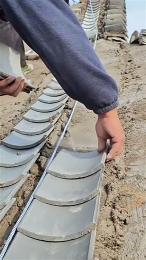 the process of installing flat roof tiles on cement mortar on the roof of a building #construction