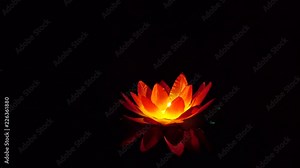 Festival of lanterns on the water. Water lantern in the shape of a Lotus with a candle flame floating at night on the water.
