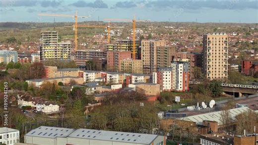 Aerial Close Up of High Rise Flats Under Construction in Stevenage UK, Drone View of Tower Cranes and Residential Building Site in England 4K