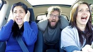 Three people driving car screaming scared about getting into accident 4K