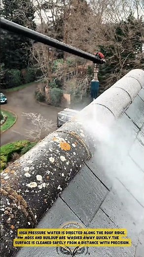 Cleaning roof ridge tiles using high pressure washer to remove moss buildup