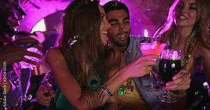 Young multi-ethnic friends drinking and celebrating Mardi Gras at bar