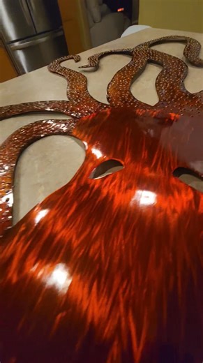 One giant octopus 32" wide x 39" tall 18guage steel,shaped in the planishing hammer,it's then ran through the English wheel, adding a few hundred of spot welds to give it the texture of suction cups on the tentacles.. then it is finished in anodized orange and a nice heavy clear coat. This particular piece is shipping out Virginia!!! | Mindwerks Metalcraft