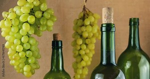 Grapes and bottles of wine on a burlap background.