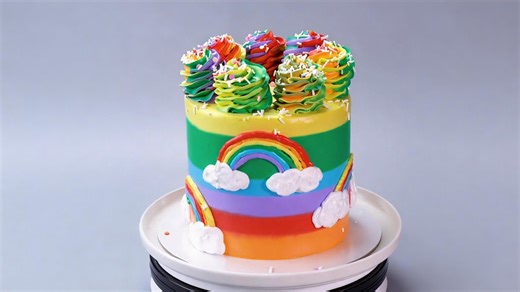 Rainbow layer cake with cloud decorations