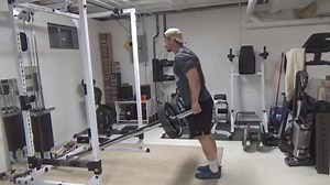 Two Barbell Landmine Shrugs...this is a very simple way to create your own shrug "machine" using a couple of barbells. You actually don't need to use a landmine for either of the bars...it just LOOKS like a landmine setup. Just brace the non-working ends of the bars against something solid - I've set my bars against the bottom cross-beam of my power rack. Because you're gripping on the other side of the actual weight, the bars won't flip. So basically stand facing either towards or away from the