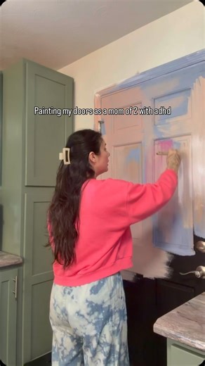 Emery Lu Causey | Movement Guide Yoga Teacher + Fitness Coach on Instagram: "Should I change the color? I’m KIDDING. I’m not. But anyways only two more coats of paint and then next is blue bookshelves happy Sunday 💕 #adhdmom #diyprojects #pinkdoor #diml #momswhoworkout"