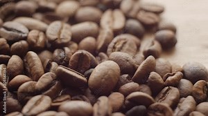 Macro of Roasted coffee beans, can be used as a background and texture. Coffee beans on the table background texture. Background full of coffe beans studio shoot.