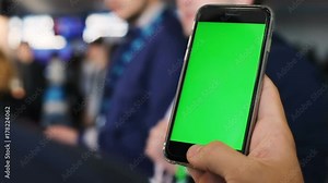 Man male hand using smart phone airport terminal urban city lifestyle traveling checking timetable schedule flight tapping green screen chromakey pointing touchscreen swapping scrolling mockup app