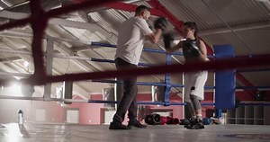 Sportswoman training with coach in gym