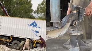 Skilled Mechanics Repairing Accidental Truck in Workshop