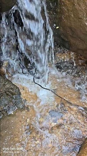 A magnificent waterfall in a mountainous environment