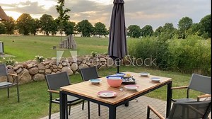 Terrace in nature with a table, with barbecue, sausages and cheese, detail view