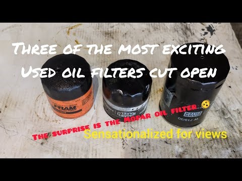 Three used oil filters from a bucket cut open