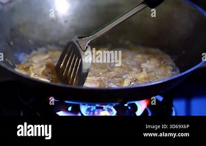 cooking process on a stove in the kitchen.