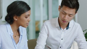 Beautiful business woman team leader training asian intern writing notes female executive sharing ideas teaching colleague in office 4k | Premium Stock Video Footage