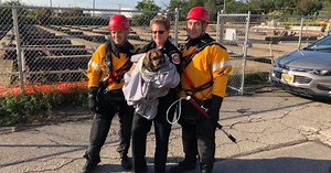 Missing dog found clinging to a pipe, rescued from an 8-foot pit of water
