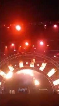 The video shows a live concert or music show taking place on a large stage with a band performing.