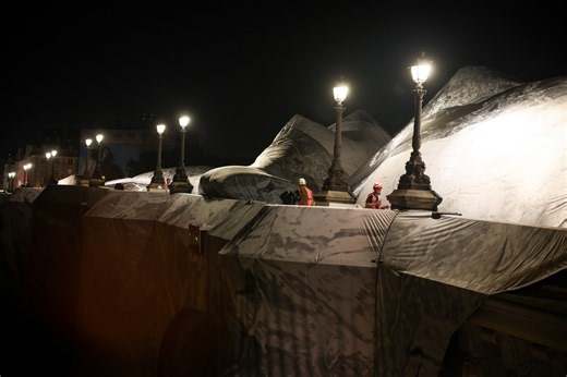 French artist JR begins his giant 'cave' art inflation over Paris' oldest bridge
